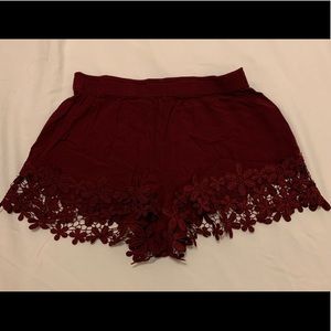 Red shorts with flower ruffles.